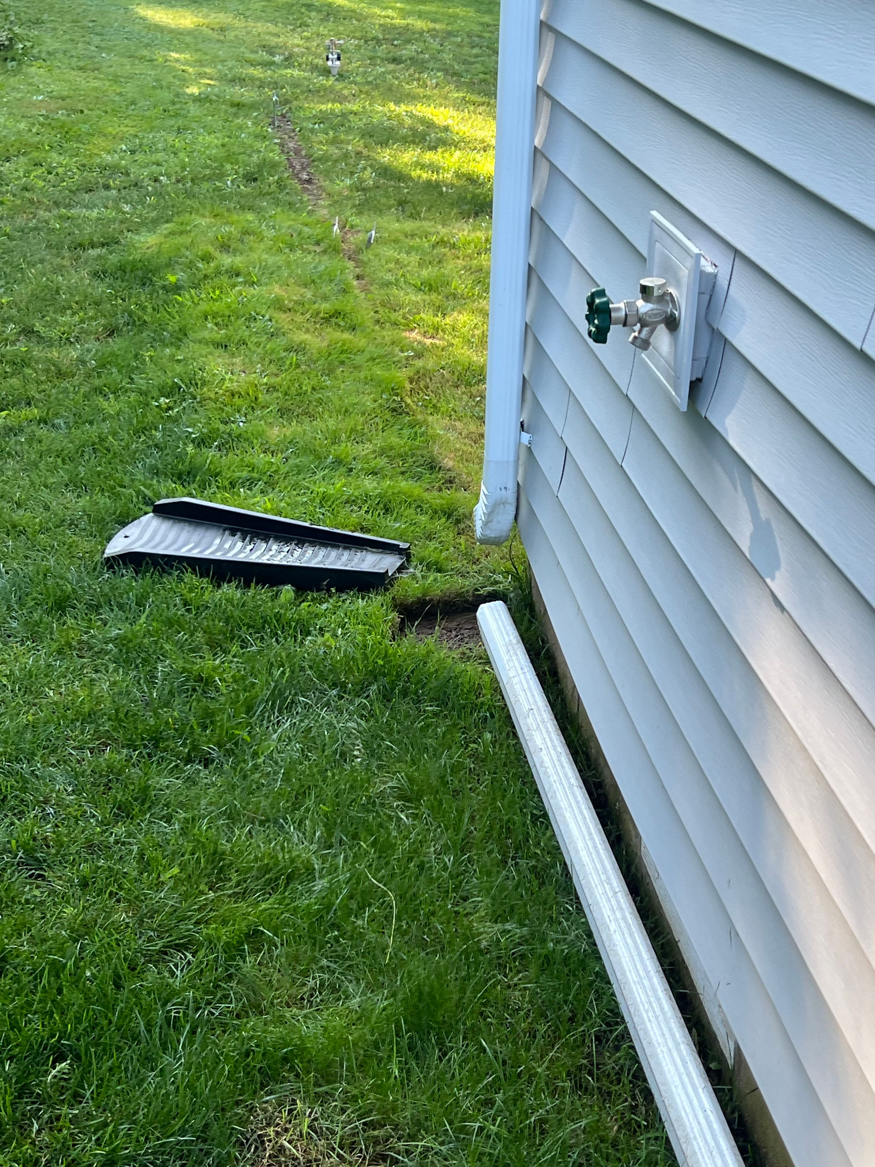 Project Drainage Pipe and Stone Bed Installation Along Home Foundation image